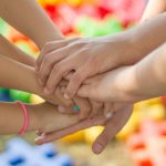 group of young hands together teamwork children