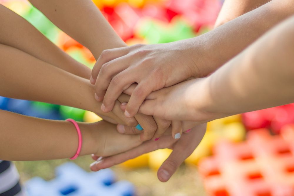 group of young hands together teamwork children